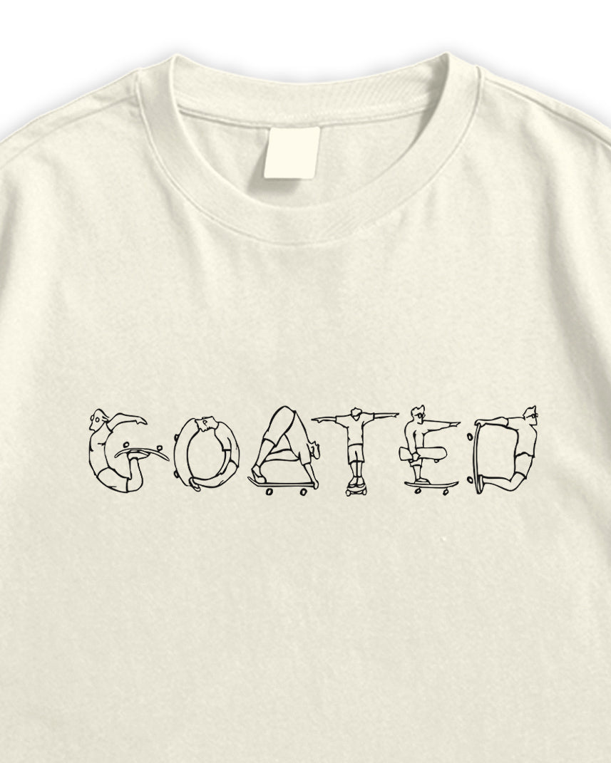 Beige t-shirt with graphic design of a person on a skateboard and text 'GOATED' on a white background