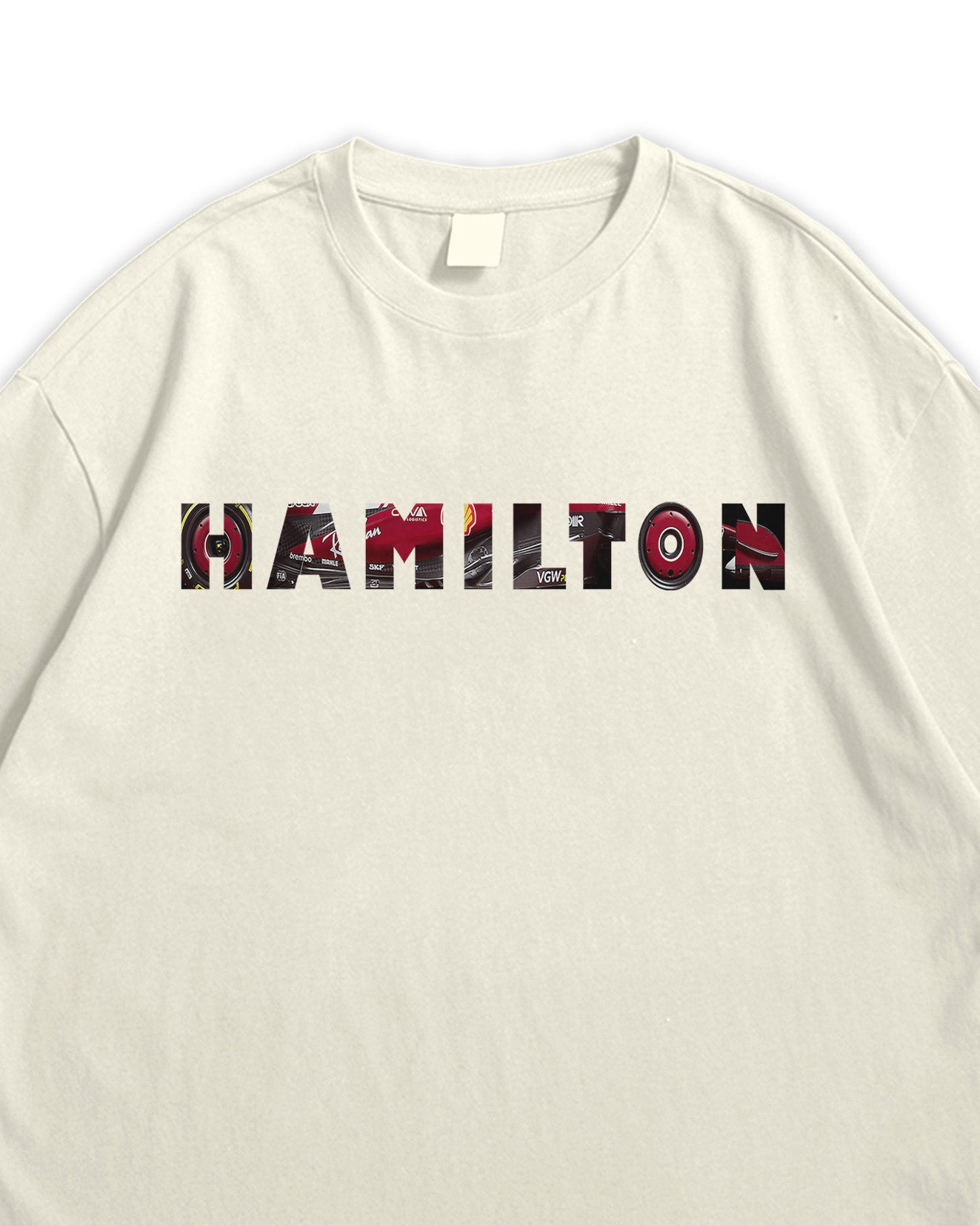 Beige t-shirt with 'HAMiLTON' printed in colorful letters on a white background